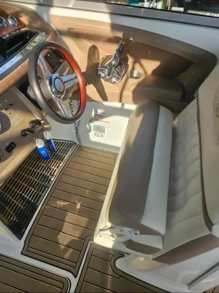 Slide: The Image of 2010 Cobalt 302 boat interior with wood accents and steering wheel. - 14