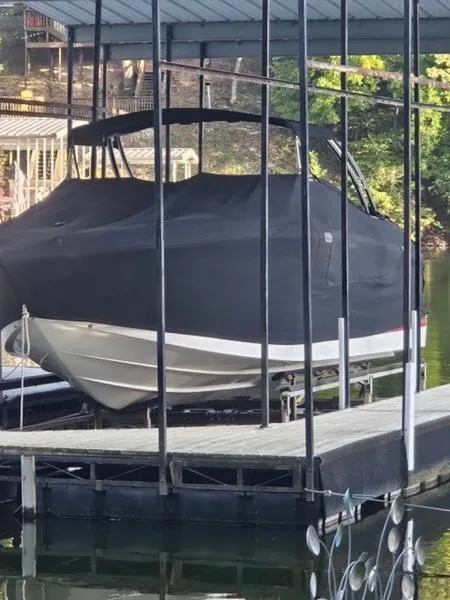 Slide: The Image of 2010 Cobalt 302 boat covered and docked in a marina. - 16