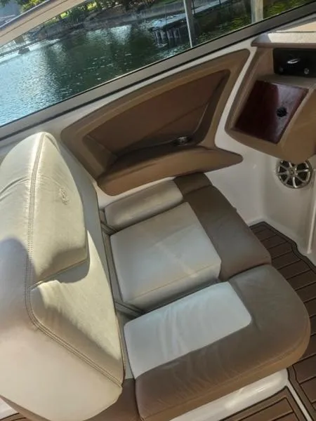 Slide: The Image of 2010 Cobalt 302 boat interior with beige and white seating. - 18