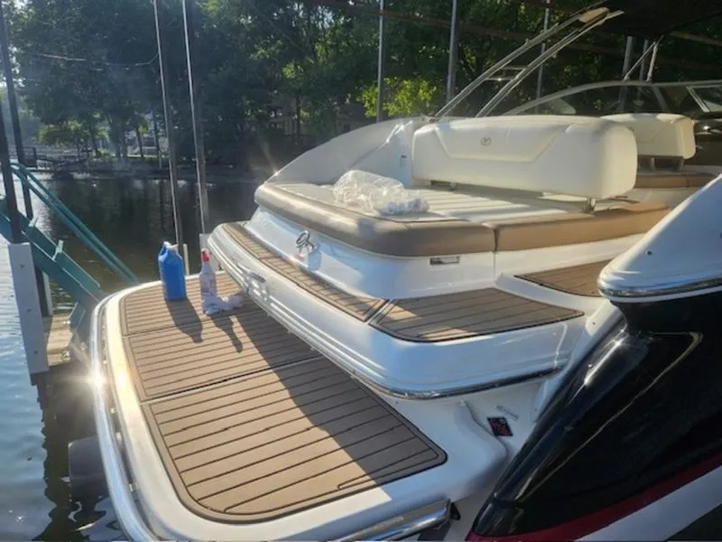 Slide: The Image of 2010 Cobalt 302 boat with spacious deck, docked by the water. - 19