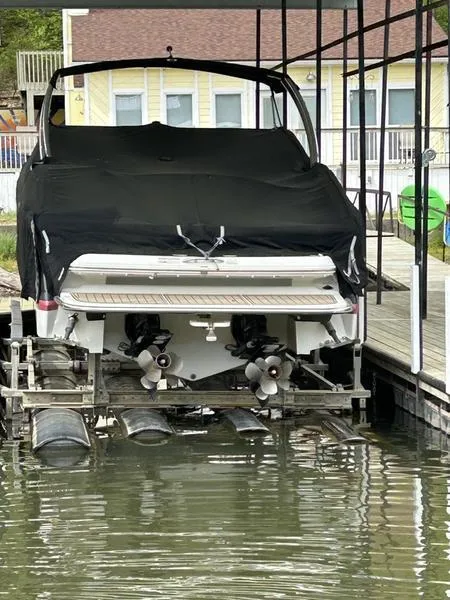 Slide: The Image of 2010 Cobalt 302 boat with cover, docked in a marina. - 2