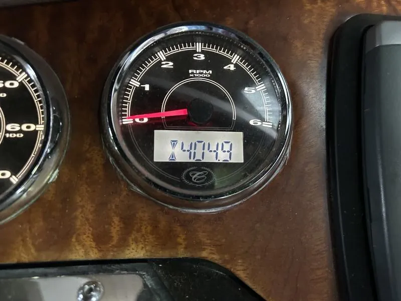 Slide: The Image of Tachometer of 2010 Cobalt 302 displaying 474.9 hours on wooden dashboard. - 20