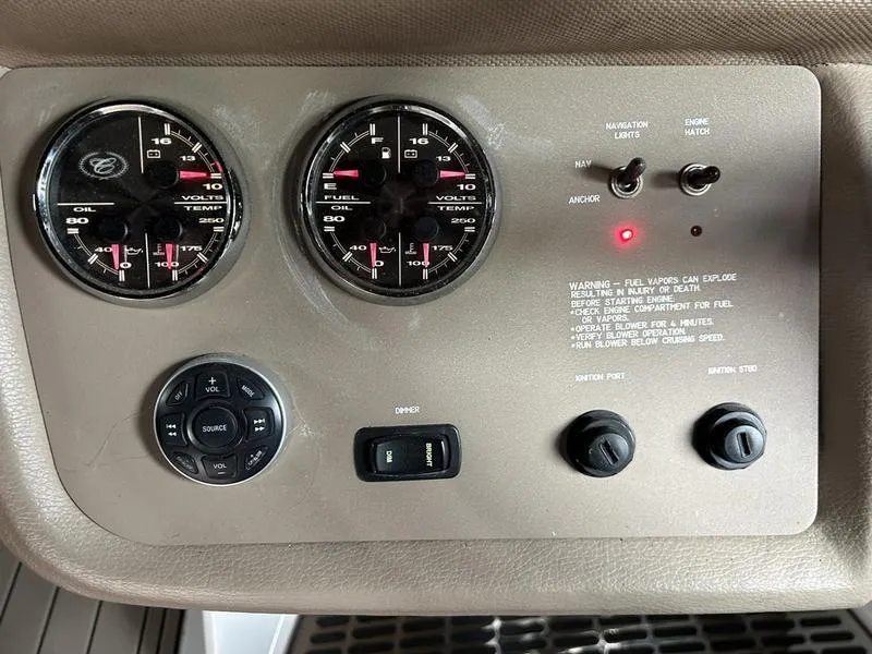 Slide: The Image of Control panel of a 2010 Cobalt 302 boat with gauges and switches. - 23