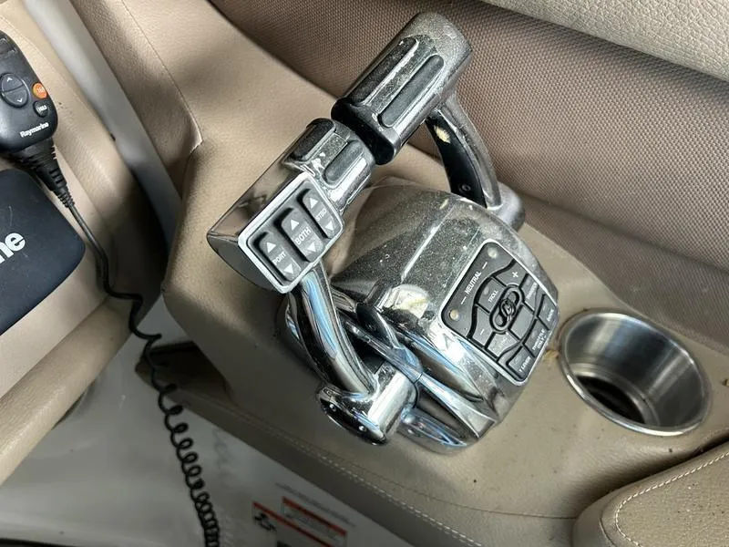 Slide: The Image of Chrome throttle controls on a 2010 Cobalt 302 boat interior. - 25
