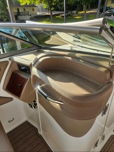 Slide: The Image of 2010 Cobalt 302 boat interior with tan seating and wood accents. - 5
