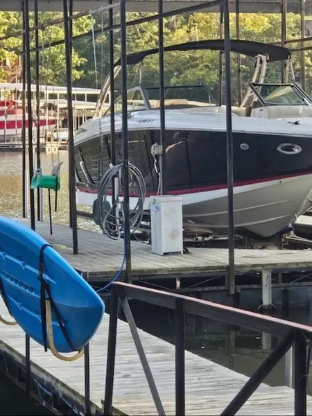 Slide: The Image of 2010 Cobalt 302 boat docked at a marina with a blue kayak nearby. - 6