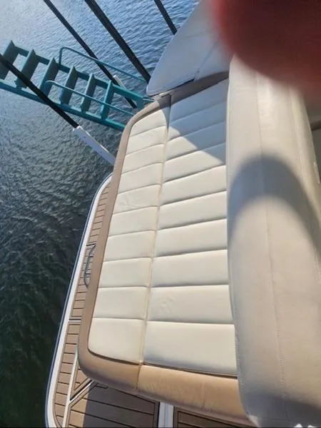 Slide: The Image of 2010 Cobalt 302 boat with beige seating, docked on calm water. - 8
