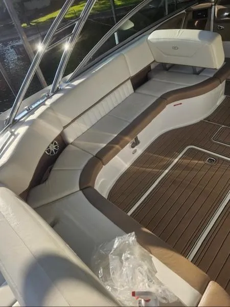 Slide: The Image of 2010 Cobalt 302 boat interior with white and brown seating, wooden flooring. - 9