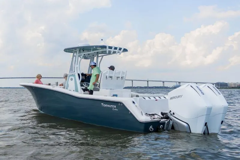 Slide: The Image of 2025 Tidewater 272 CC Adventure boat on trailer, sunlit, outdoor display. - 1