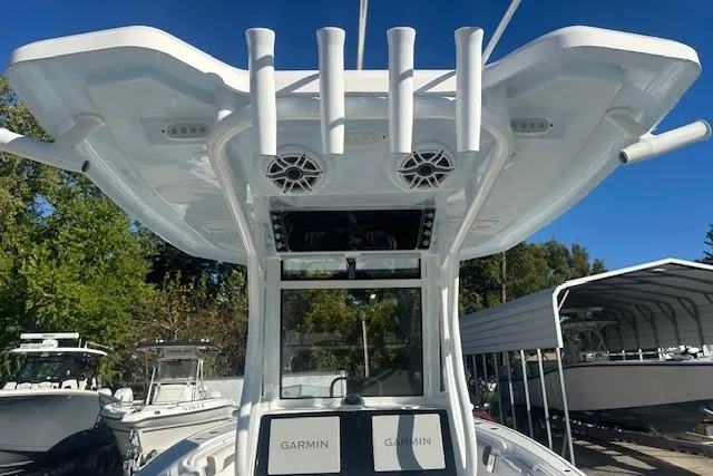 Slide: The Image of 2025 Tidewater 272 CC Adventure boat with Garmin electronics and rod holders. - 10