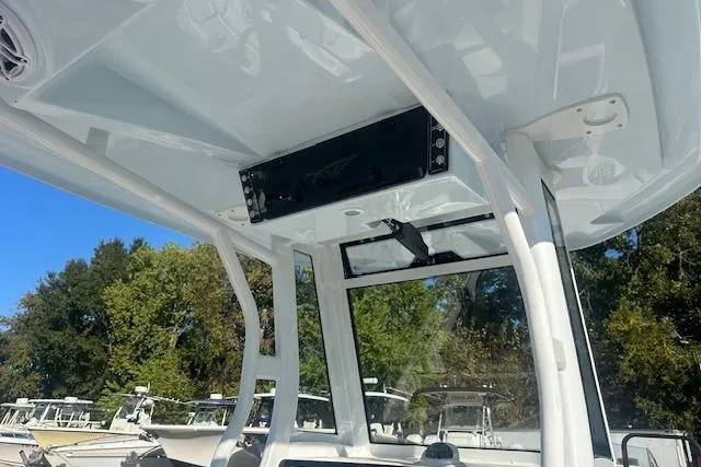 Slide: The Image of 2025 Tidewater 272 CC Adventure boat interior with modern console and overhead storage. - 11