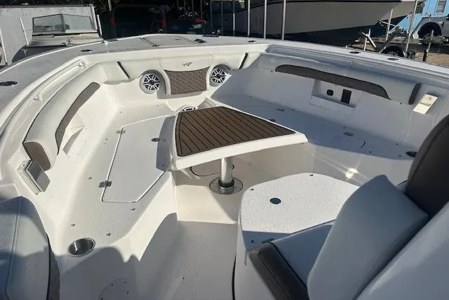 Slide: The Image of 2025 Tidewater 272 CC Adventure boat interior with seating and table. - 13