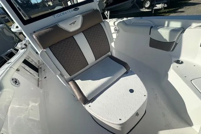 Slide: The Image of 2025 Tidewater 272 CC Adventure boat interior with cushioned seating. - 16