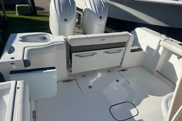 Slide: The Image of 2025 Tidewater 272 CC Adventure boat interior with dual engines and seating area. - 17