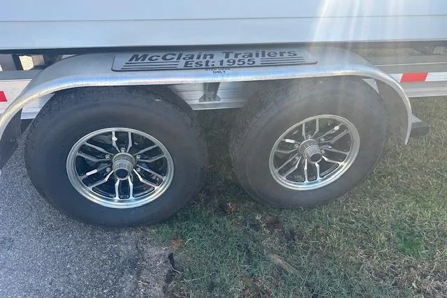 Slide: The Image of Trailer wheels of a 2025 Tidewater 272 CC Adventure boat on McClain Trailers. - 18