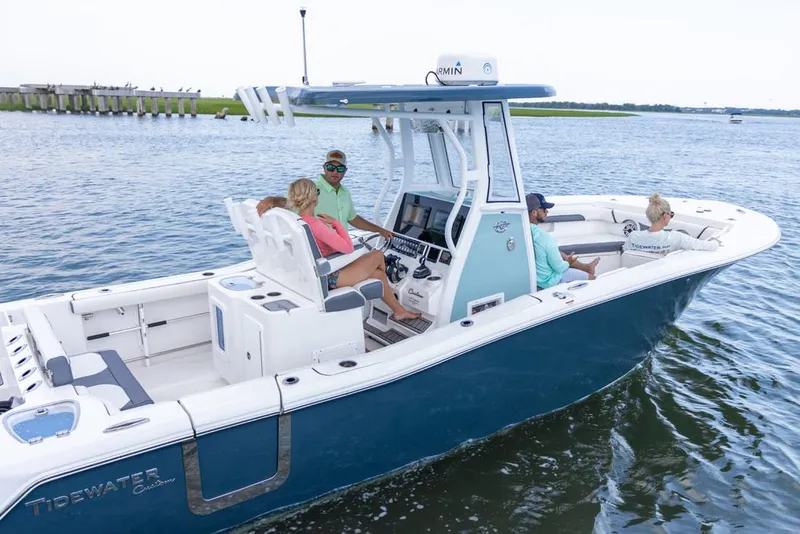 Slide: The Image of 2025 Tidewater 272 CC Adventure with dual Yamaha 200 engines, parked outdoors. - 2