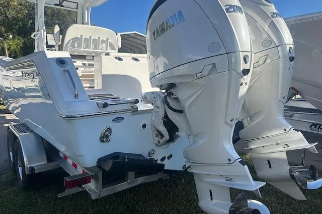 Slide: The Image of 2025 Tidewater 272 CC Adventure boat with dual Yamaha outboard engines on a trailer. - 4