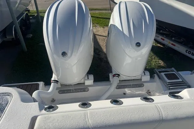 Slide: The Image of 2025 Tidewater 272 CC Adventure boat with dual outboard engines, rear view. - 5