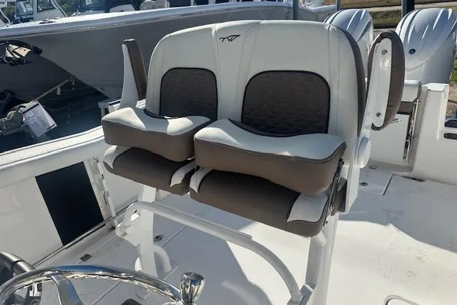 Slide: The Image of 2025 Tidewater 272 CC Adventure boat seats, featuring dual cushioned helm chairs. - 8