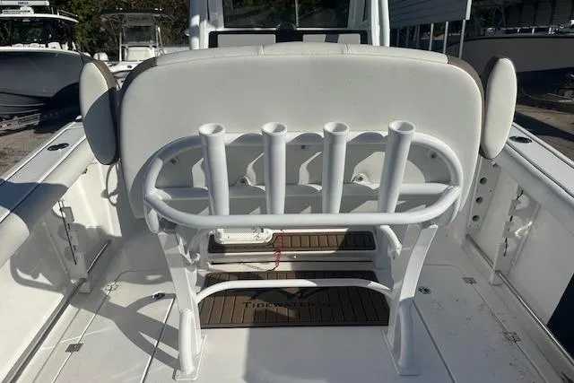 Slide: The Image of 2025 Tidewater 272 CC Adventure boat interior with rod holders and seating. - 9
