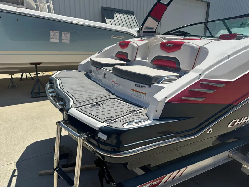 Slide: The Image of 2016 Chaparral Vortex 203 VRX boat with swim platform and seating, docked outdoors. - 12