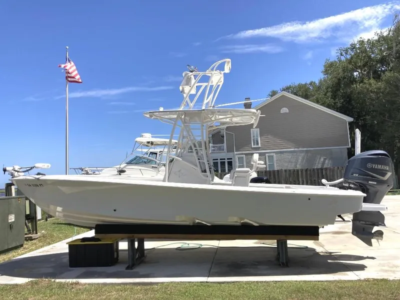 Slide: The Image of 2016 SeaVee 270Z boat on display with Yamaha outboard motor, American flag in background. - 1
