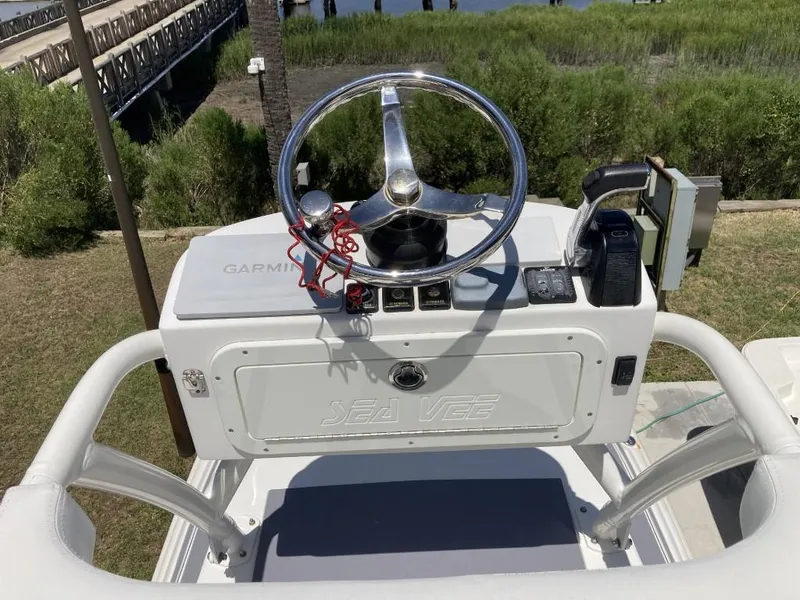 Slide: The Image of 2016 SeaVee 270Z boat helm with steering wheel and navigation equipment. - 12