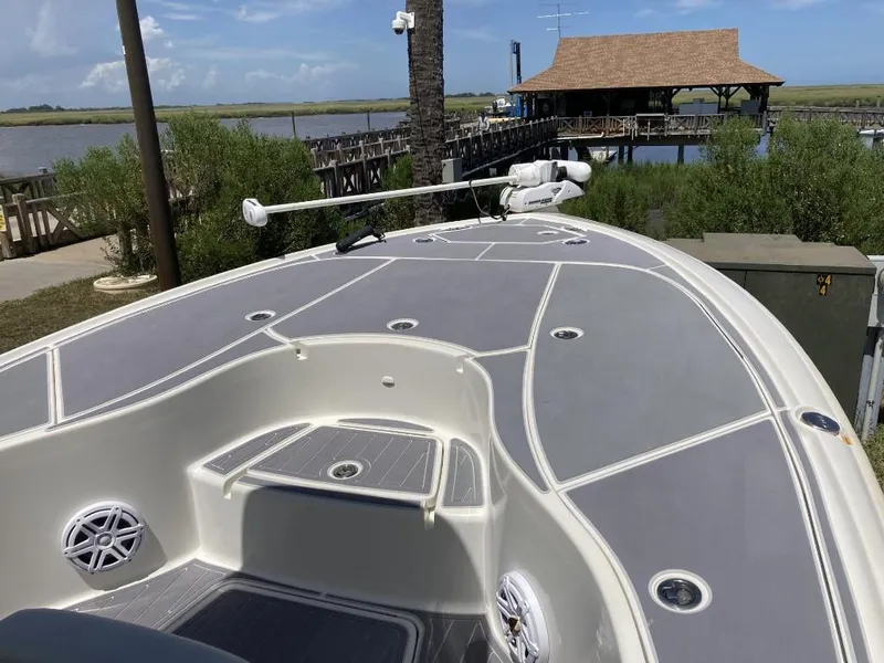 Slide: The Image of 2016 SeaVee 270Z boat docked near a scenic waterfront with lush greenery. - 16
