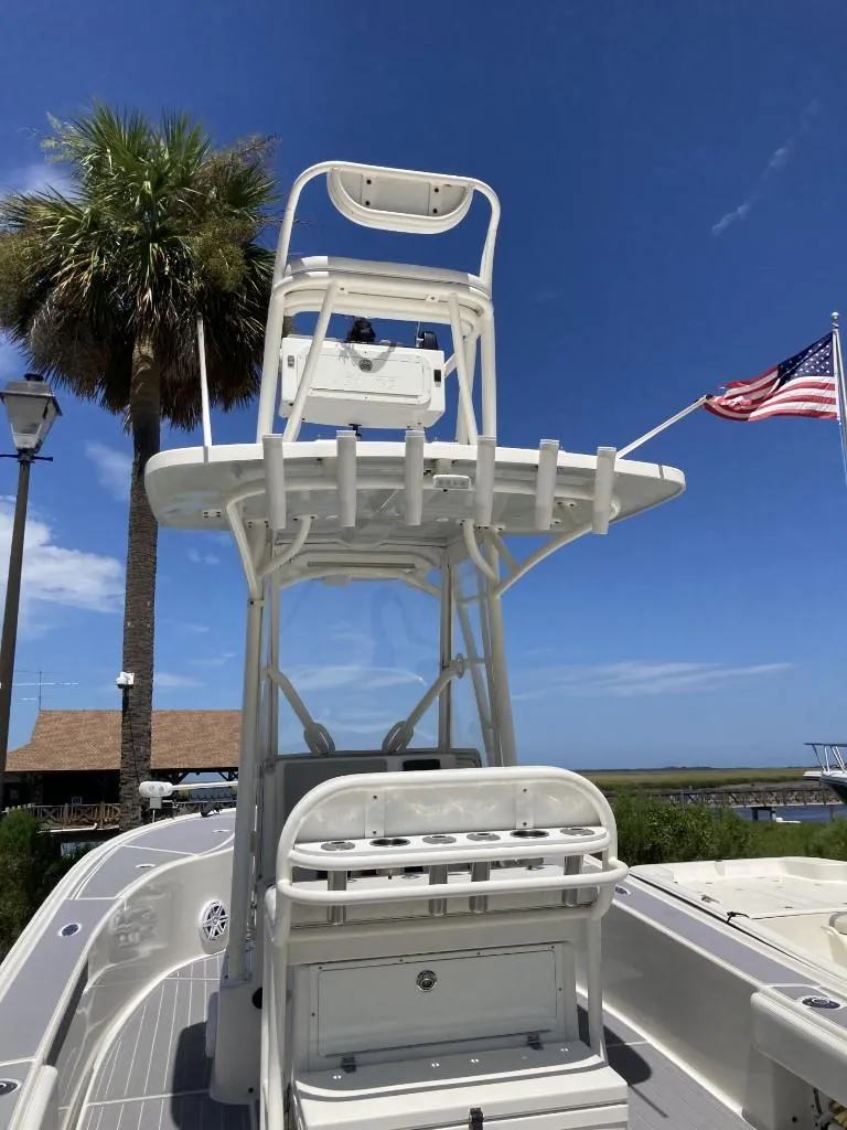 Slide: The Image of 2016 SeaVee 270Z boat with tower, American flag, and palm tree in background. - 18