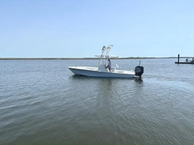 Slide: The Image of 2016 SeaVee 270Z boat cruising on calm waters under clear blue sky. - 19