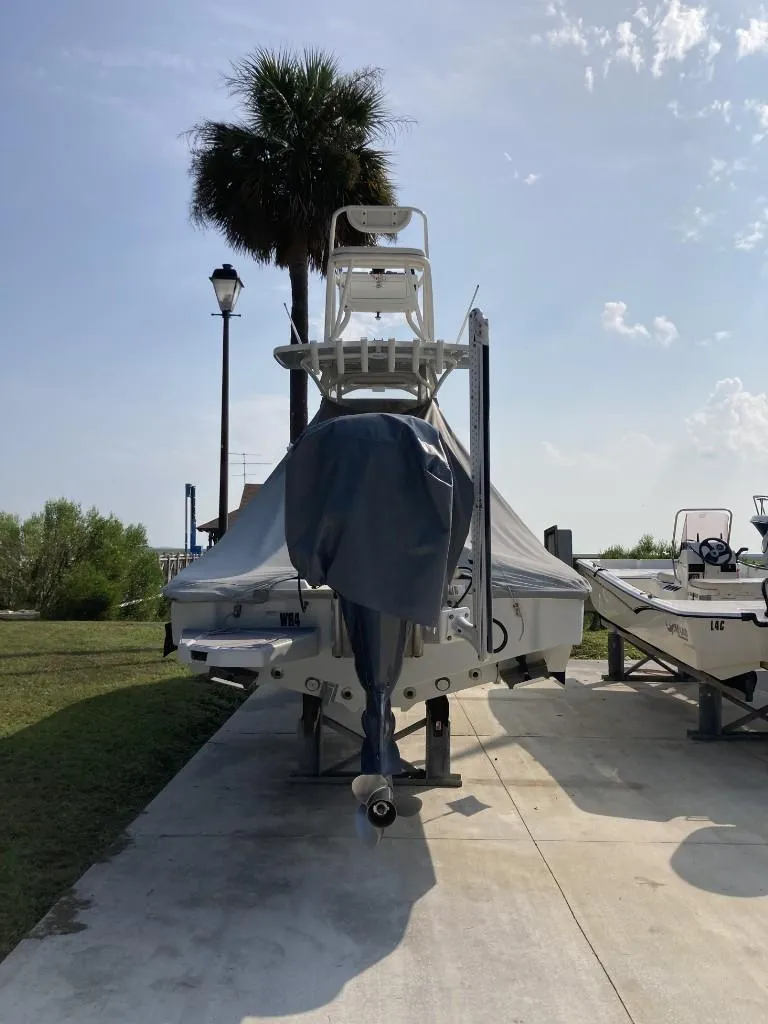 Slide: The Image of 2016 SeaVee 270Z boat on trailer, covered, with palm tree and clear sky background. - 4