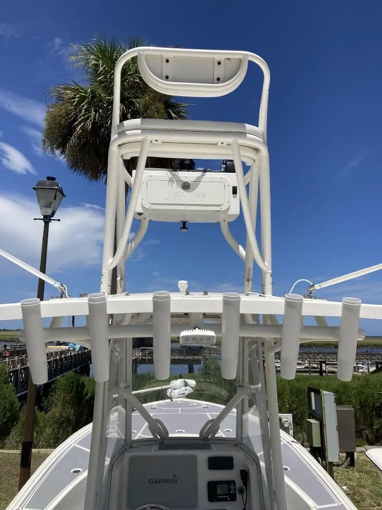 Slide: The Image of 2016 SeaVee 270Z boat with tower and rod holders under a clear blue sky. - 7