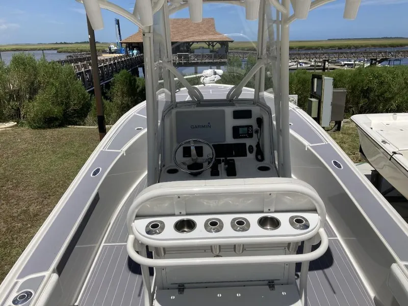 Slide: The Image of 2016 SeaVee 270Z boat with center console and Garmin navigation system, docked near a marina. - 8