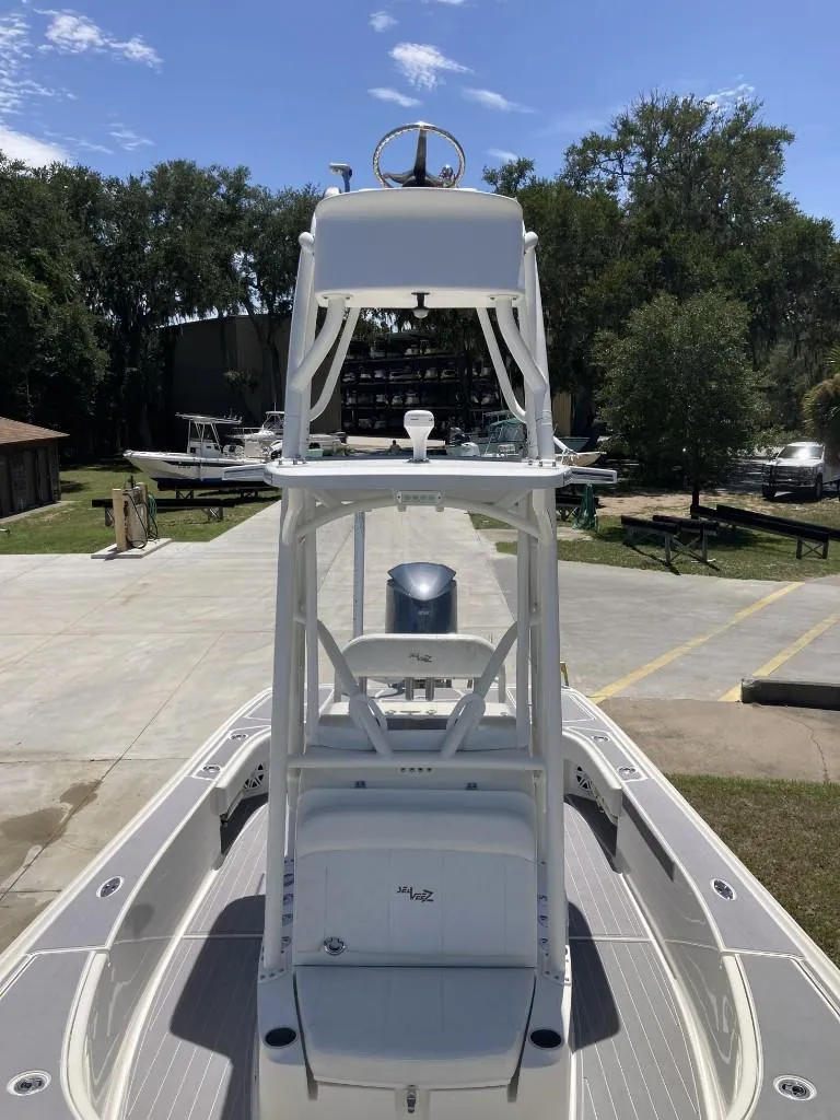 Slide: The Image of 2016 SeaVee 270Z boat with tower, docked outdoors under clear sky. - 9