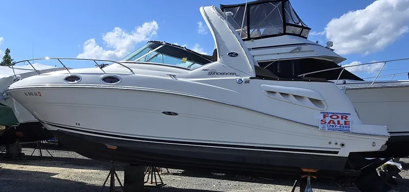 The Image of 2007 Sea Ray 260 Sundancer boat for sale, displayed on stands, clear sky background. - 0