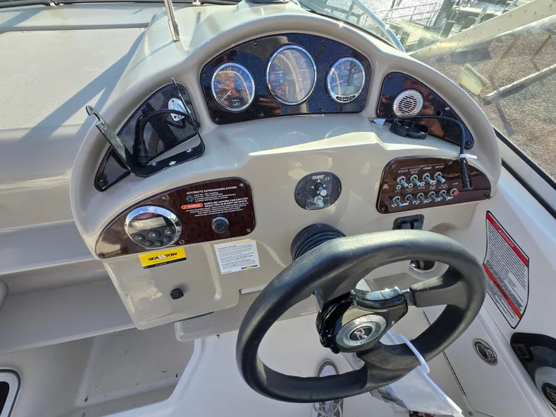 Slide: The Image of Steering console of a 2007 Sea Ray 260 Sundancer boat with gauges and controls. - 10