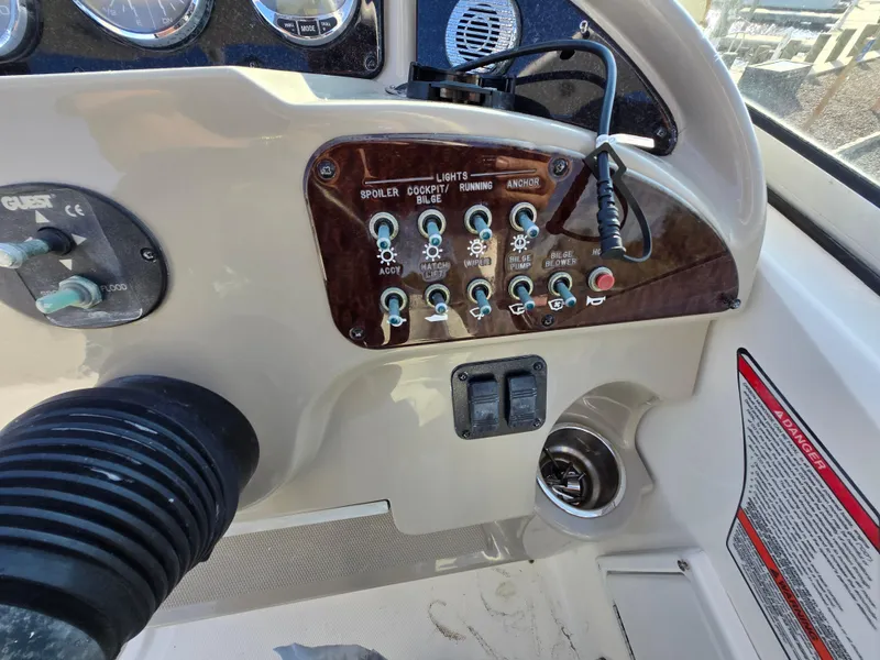 Slide: The Image of Control panel of a 2007 Sea Ray 260 Sundancer boat with switches and gauges. - 11