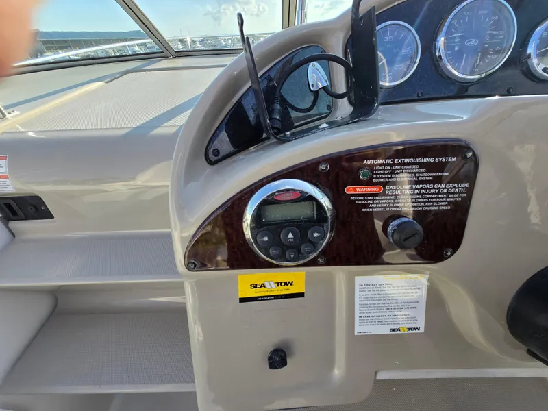 Slide: The Image of Dashboard of a 2007 Sea Ray 260 Sundancer boat with gauges and controls. - 12