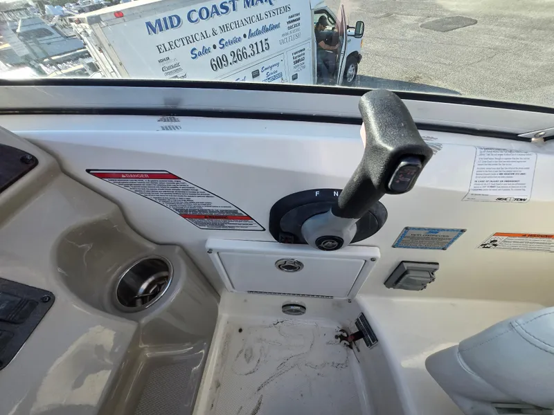 Slide: The Image of Control panel of a 2007 Sea Ray 260 Sundancer boat with throttle lever. - 13
