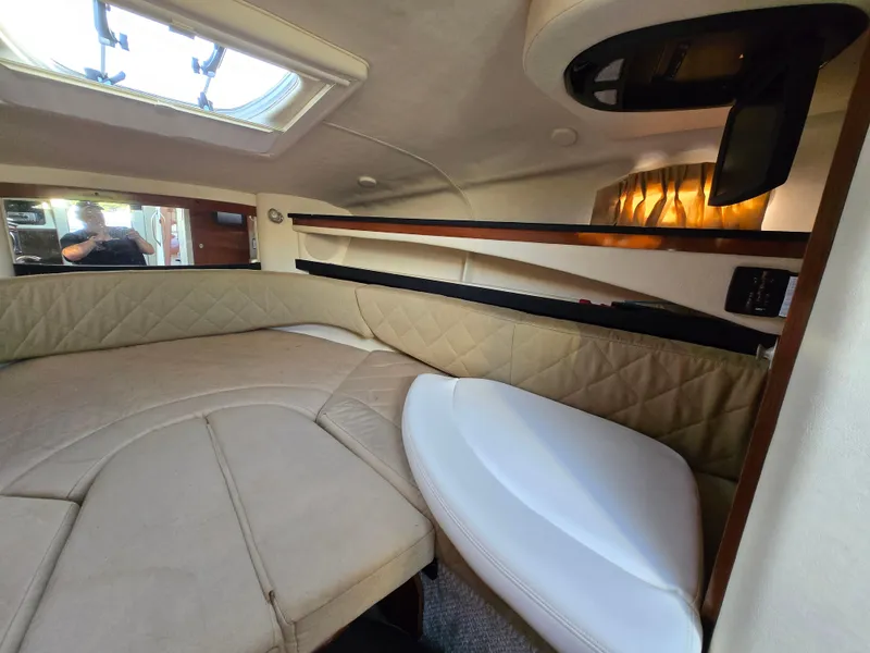 Slide: The Image of Interior cabin of 2007 Sea Ray 260 Sundancer with beige upholstery and overhead lighting. - 15