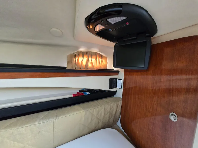 Slide: The Image of 2007 Sea Ray 260 Sundancer cabin interior with TV and ambient lighting. - 20