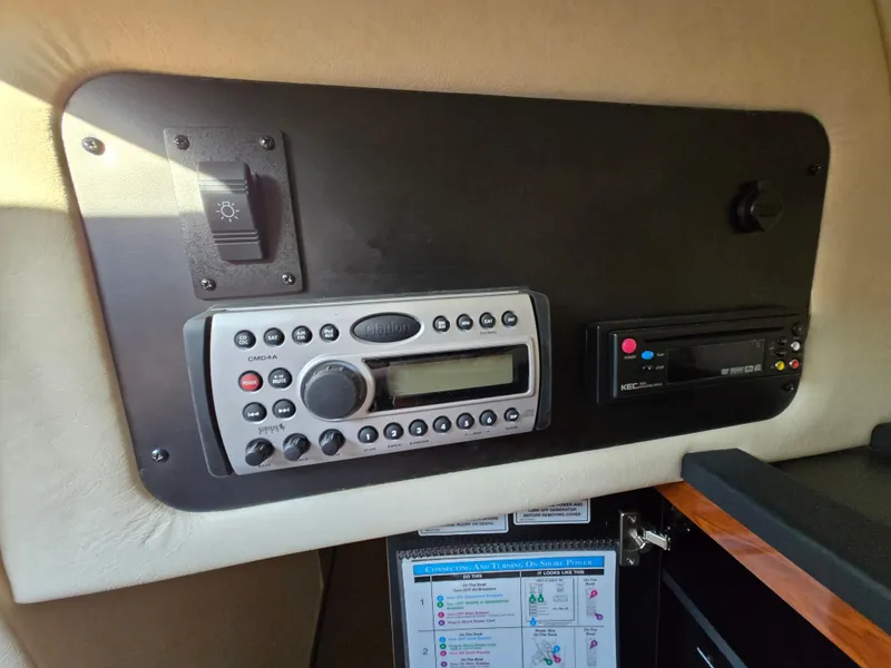 Slide: The Image of Control panel of a 2007 Sea Ray 260 Sundancer boat with radio and switches. - 24