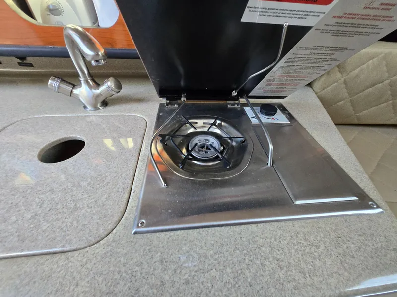 Slide: The Image of 2007 Sea Ray 260 Sundancer galley with stove and sink. - 25