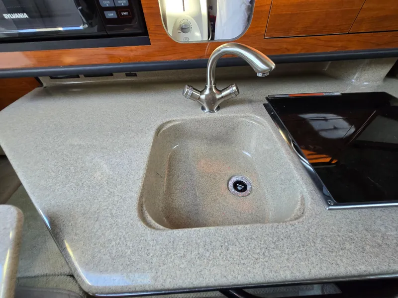 Slide: The Image of 2007 Sea Ray 260 Sundancer galley sink with faucet and countertop. - 26