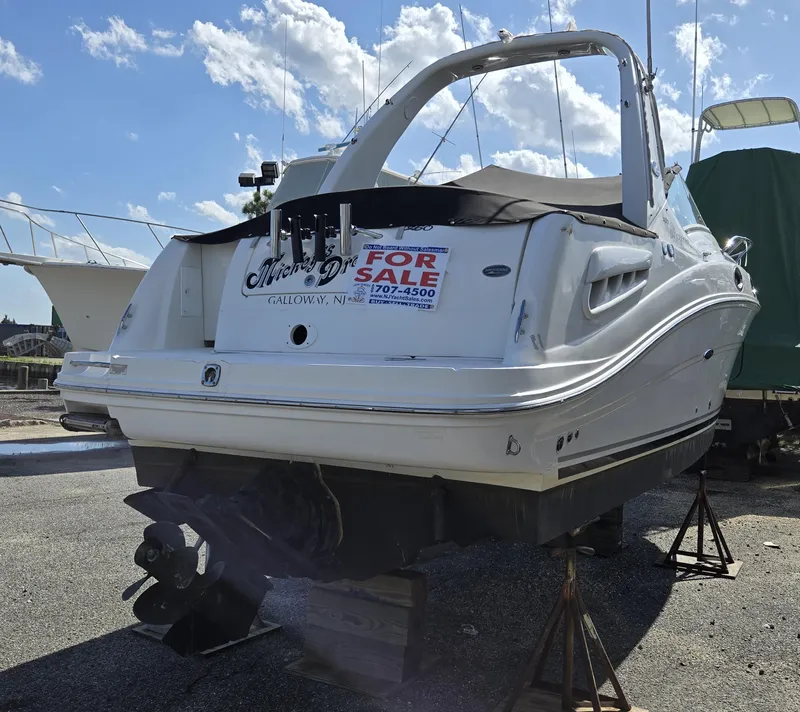 Slide: The Image of 2007 Sea Ray 260 Sundancer boat for sale, displayed on stands, sunny day. - 3
