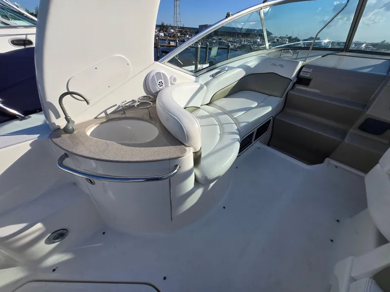 Slide: The Image of 2007 Sea Ray 260 Sundancer interior with seating and sink, docked at marina. - 6