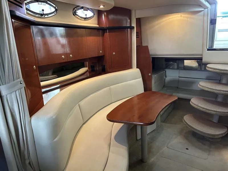 Slide: The Image of Luxurious 2005 Sea Ray 320 Sun Dancer cabin interior with elegant seating and wooden accents. - 10