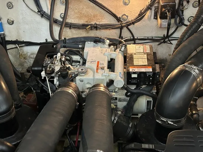 Slide: The Image of Engine compartment of a 2005 Sea Ray 320 Sun Dancer boat, showing mechanical components. - 12