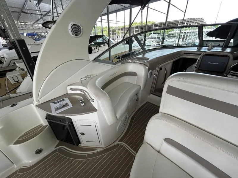 Slide: The Image of Interior of 2005 Sea Ray 320 Sun Dancer boat with sleek seating and modern dashboard. - 14