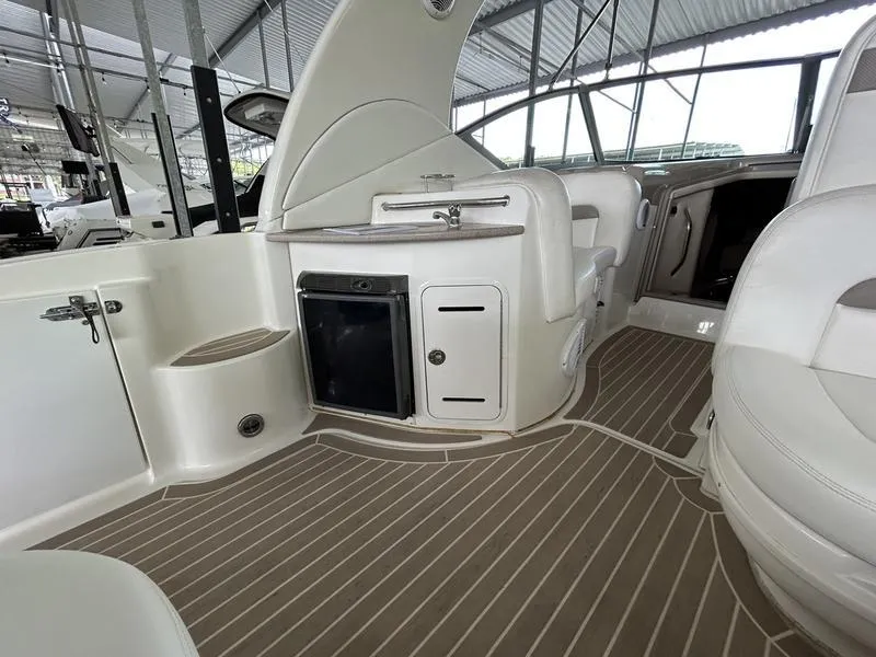 Slide: The Image of 2005 Sea Ray 320 Sun Dancer interior with kitchenette and seating area. - 15